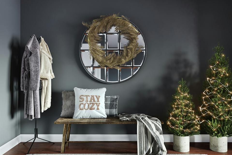 dark wood look flooring in entry way and mini lit trees for holiday.